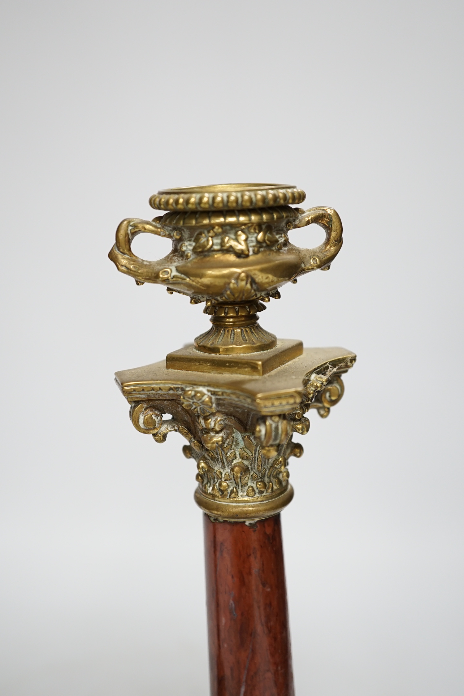 A pair of 19th century brass mounted rouge marble candlesticks, 29cm (a.f.)